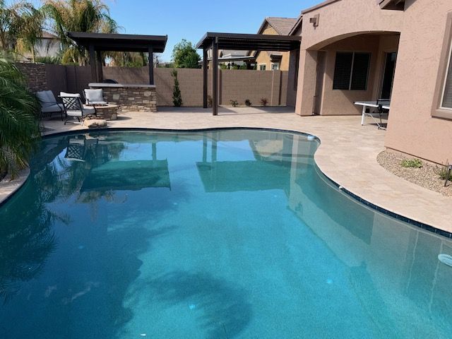 A large swimming pool in the backyard of a house