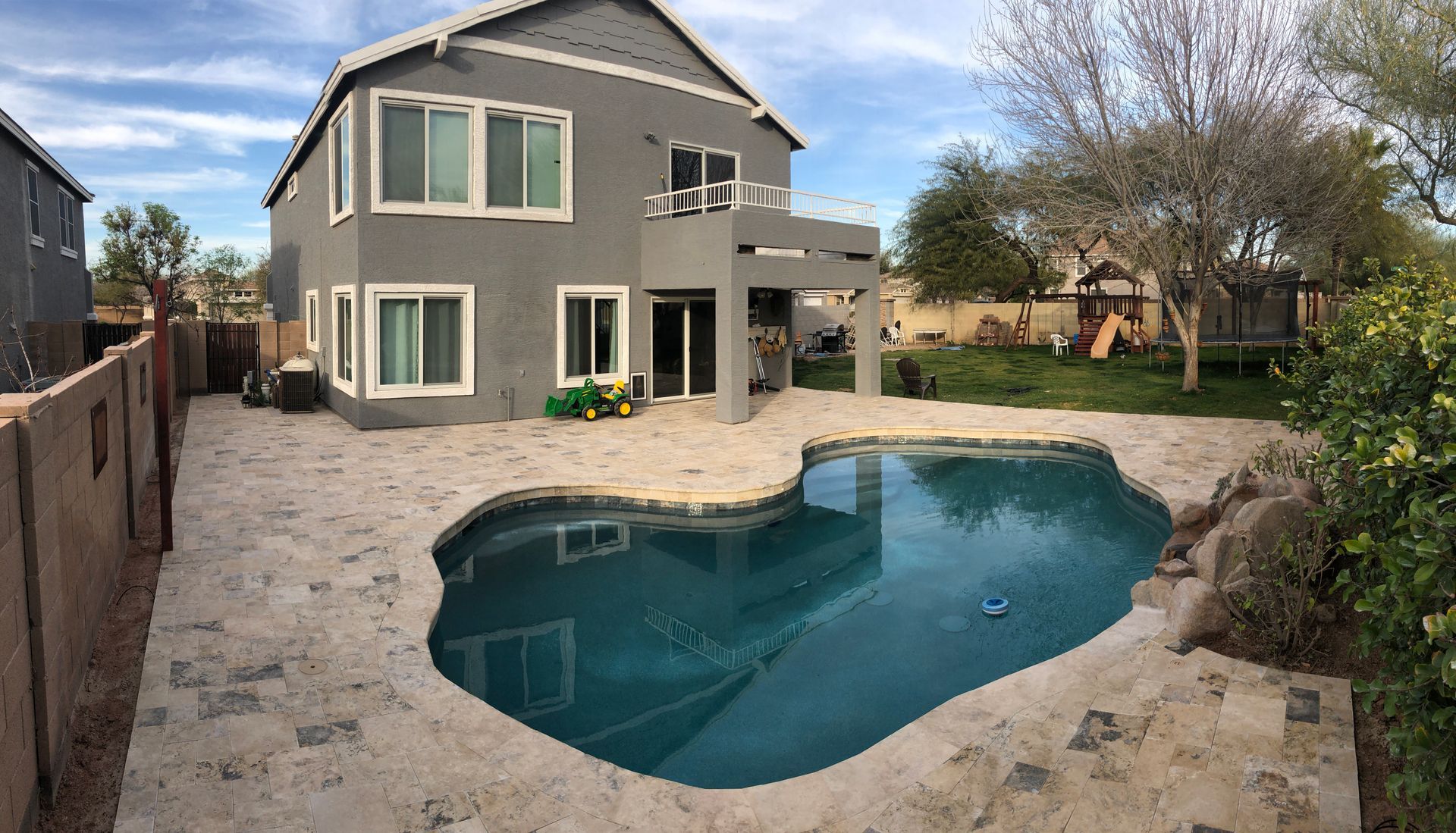 A large house with a swimming pool in front of it
