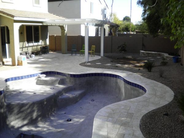 A backyard with a swimming pool and a pergola