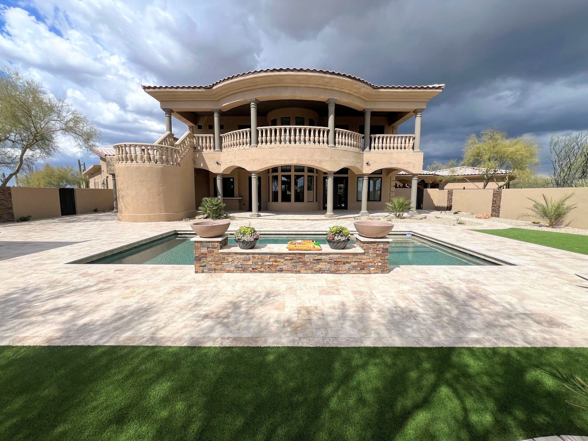 A large house with a swimming pool in front of it