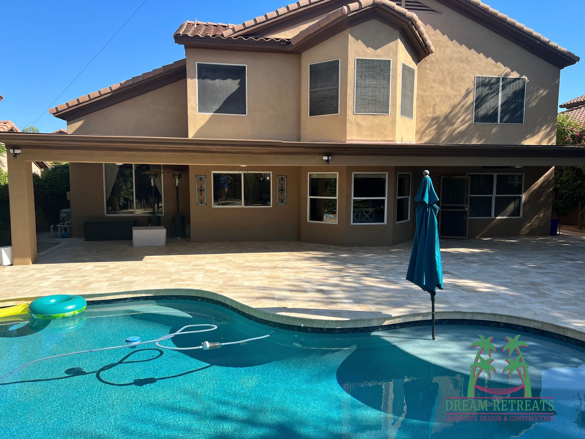 A large house with a swimming pool in front of it