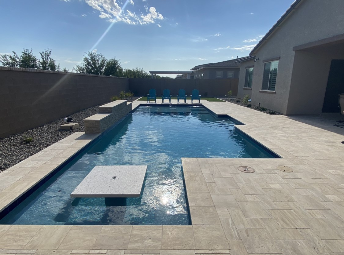 A large swimming pool in the backyard of a house