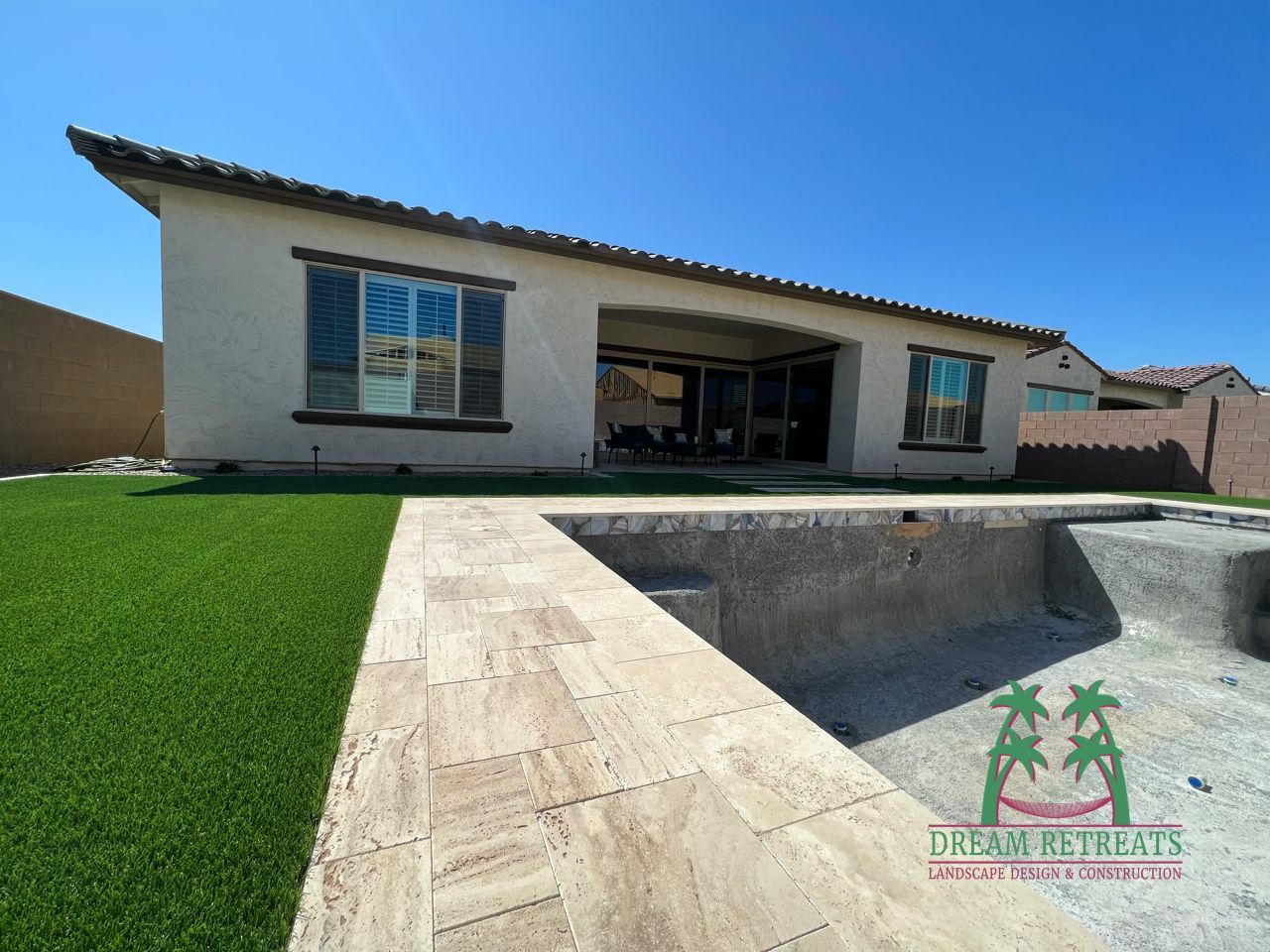 A house with a swimming pool in front of it
