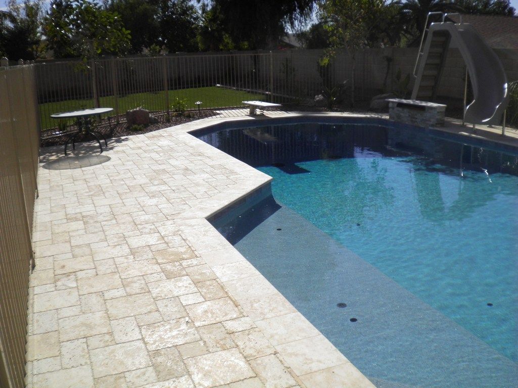 A large swimming pool with a staircase leading to it
