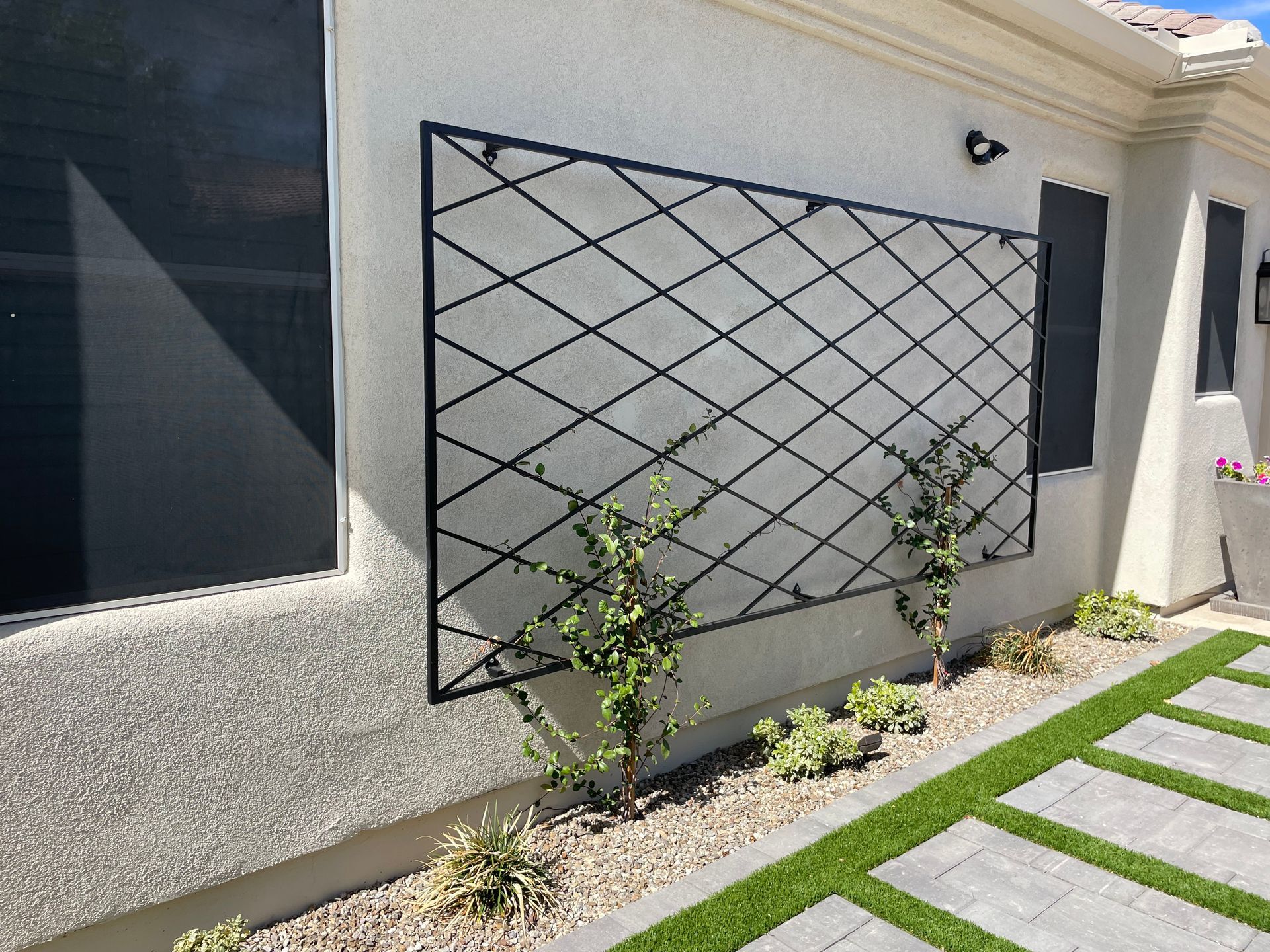 A house with a trellis on the side of it.