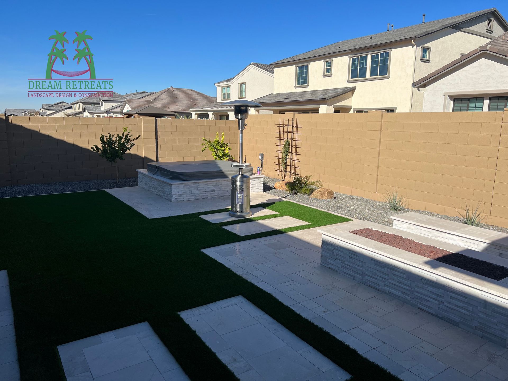 A backyard with a fence and a hot tub