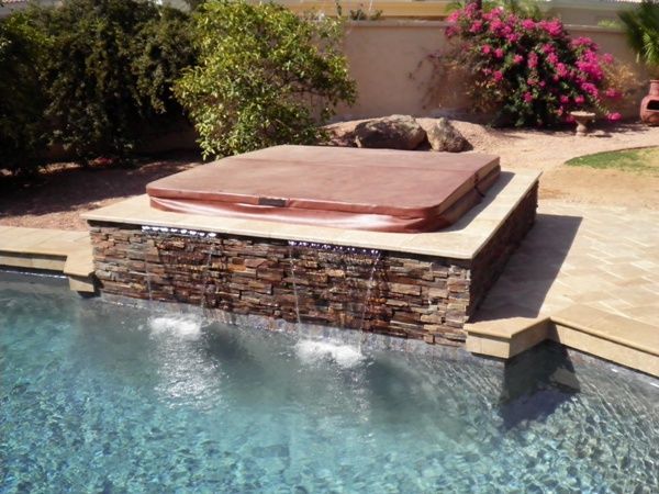 A hot tub is sitting in the middle of a swimming pool