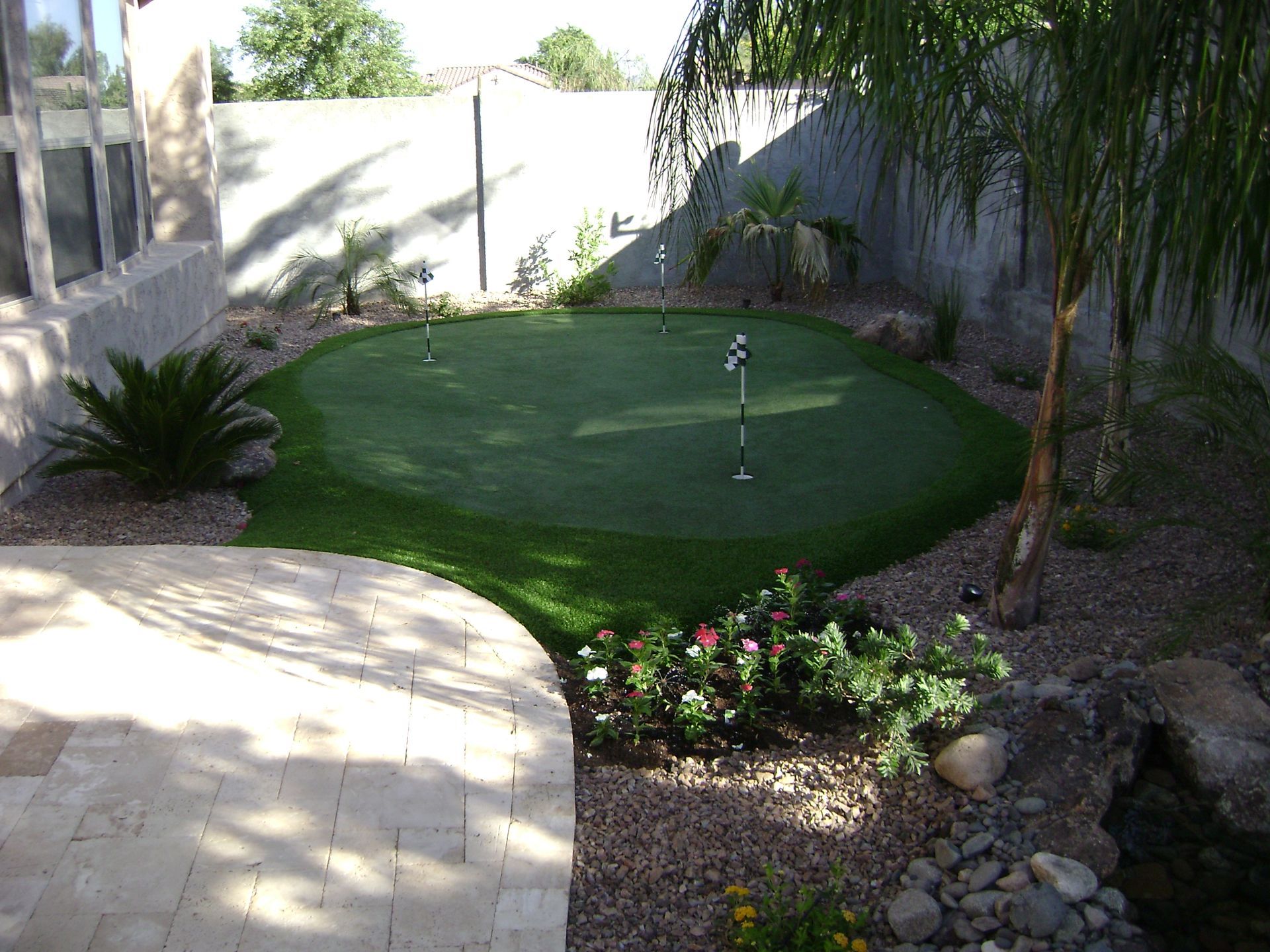 A putting green in the backyard of a house