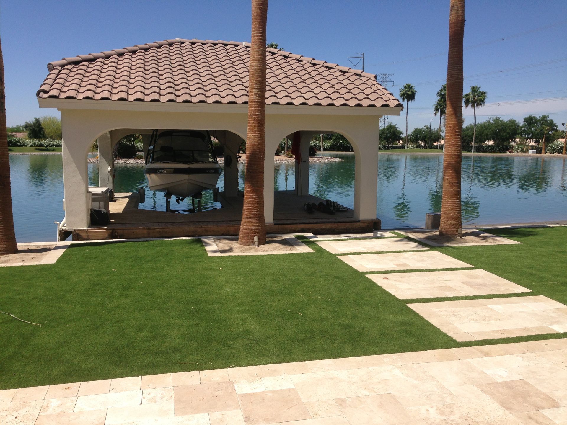 A gazebo overlooking a body of water with palm trees