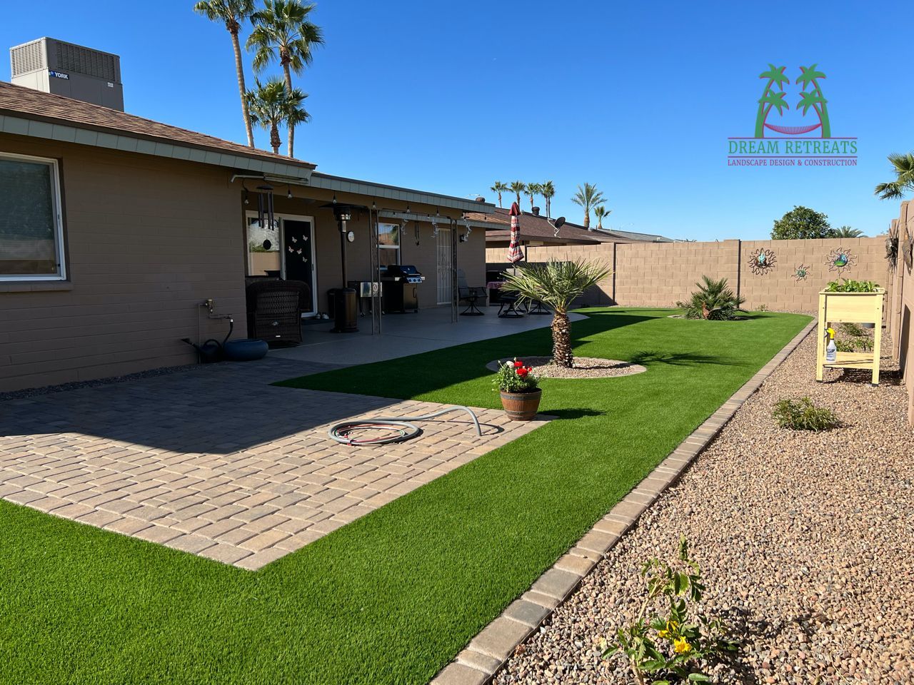 A house with a patio and a lawn in front of it