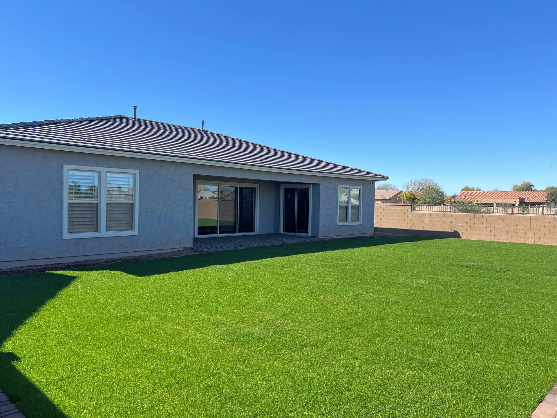 A house with a large lawn in front of it.