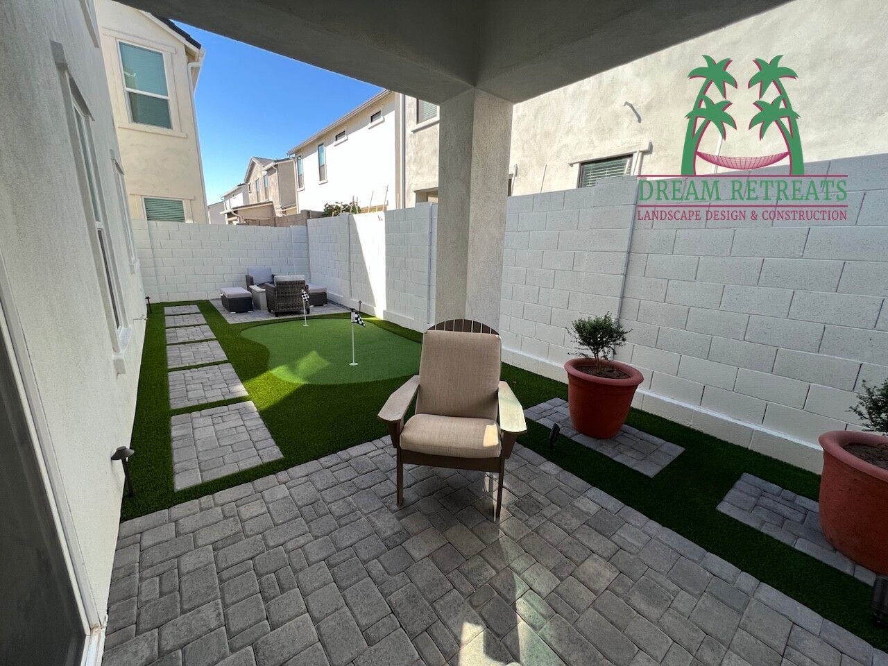 A patio with a chair and a putting green