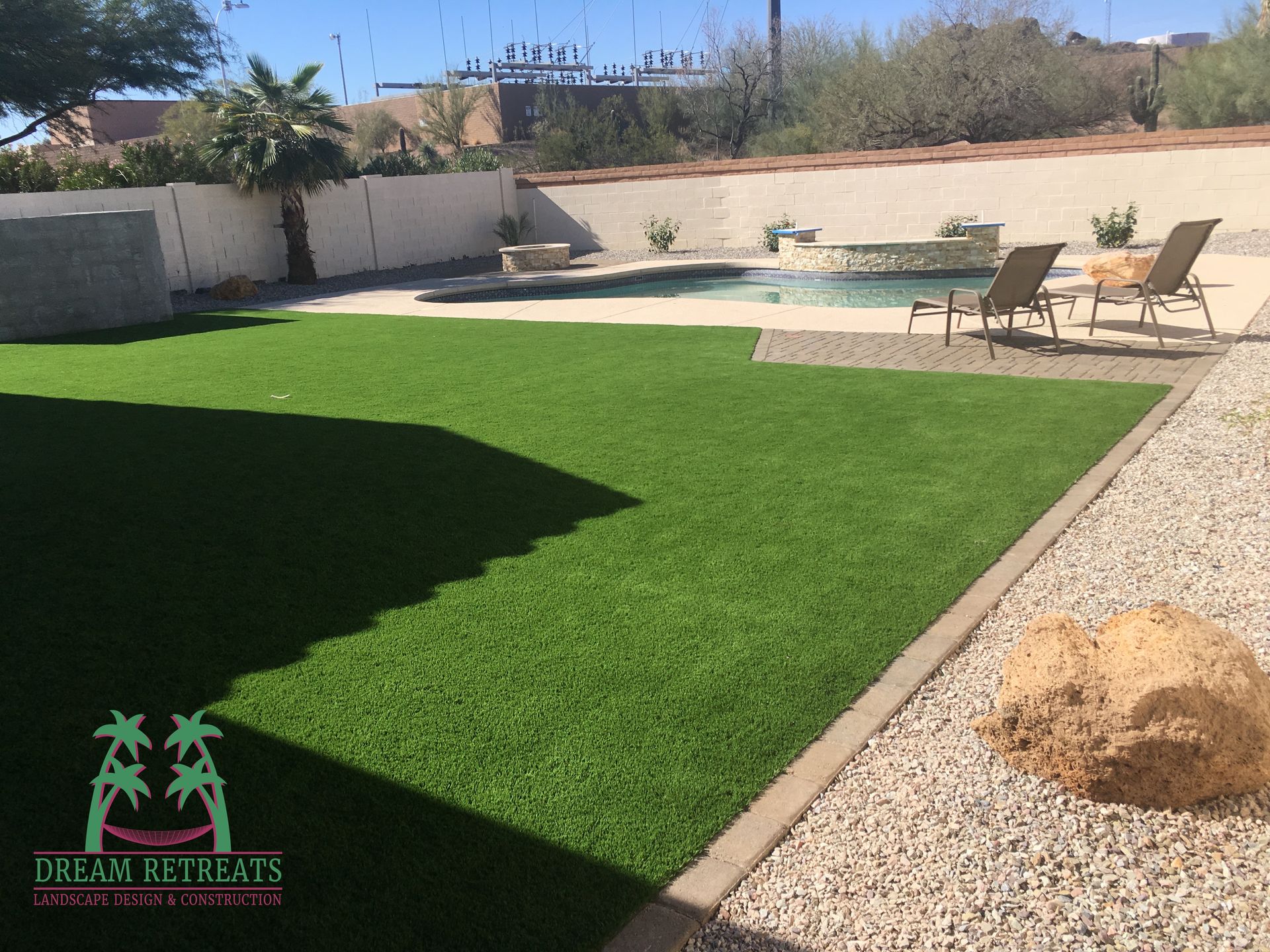 A picture of a backyard with a logo for dream retreats