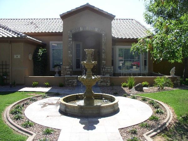 A house with a fountain in front of it