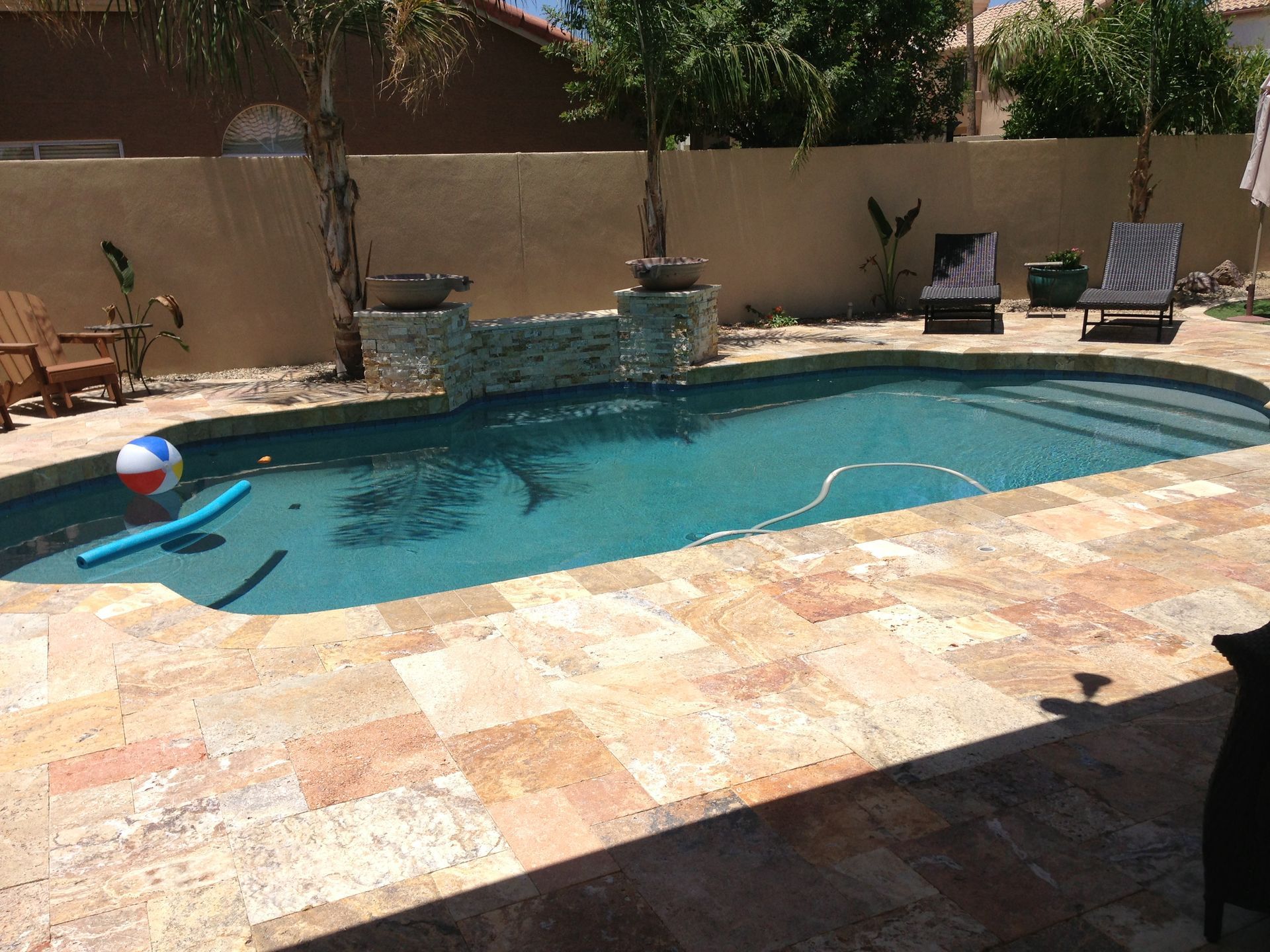 A large swimming pool with a beach ball in it