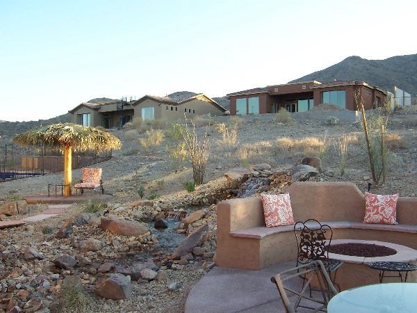 A patio area with a fire pit and a couch