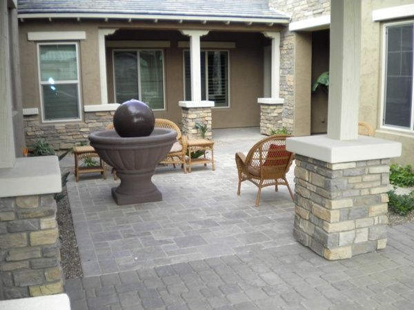 A patio with a fountain in the middle of it