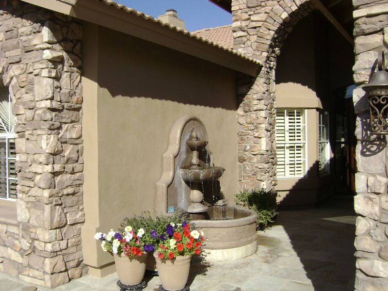 A stone building with a fountain in front of it