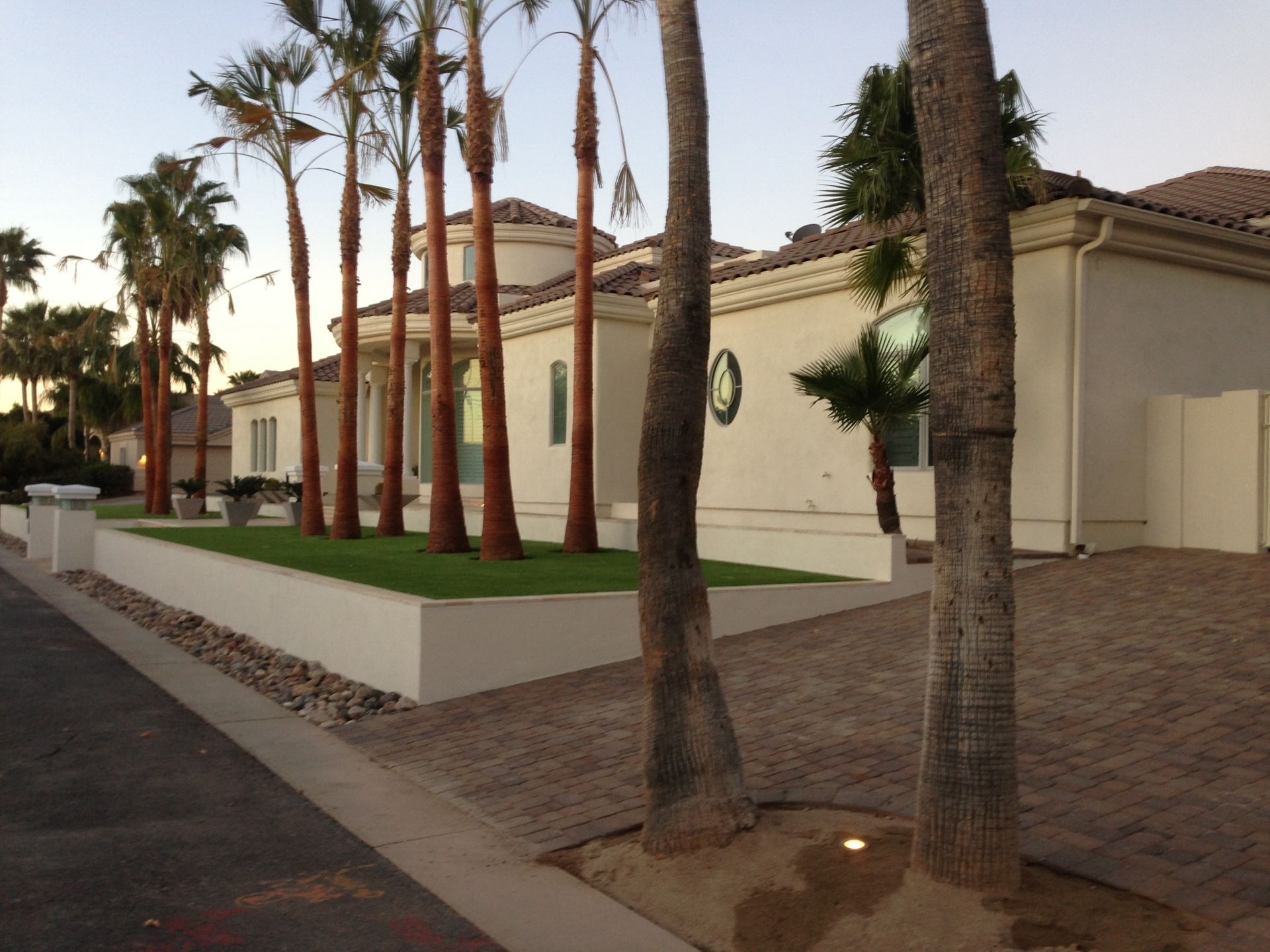 A white house with palm trees in front of it