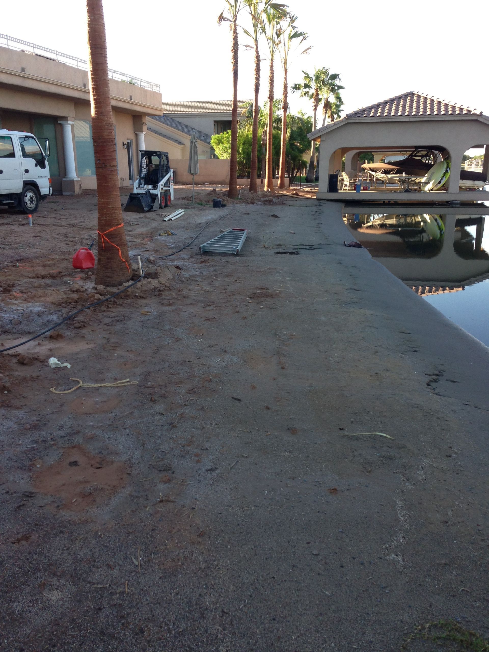 A white truck is parked next to a body of water