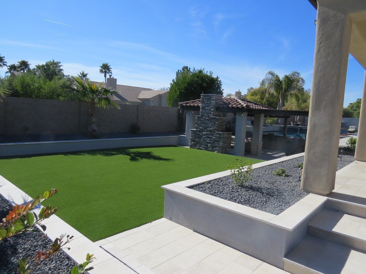 A house with a large lawn and steps leading to it