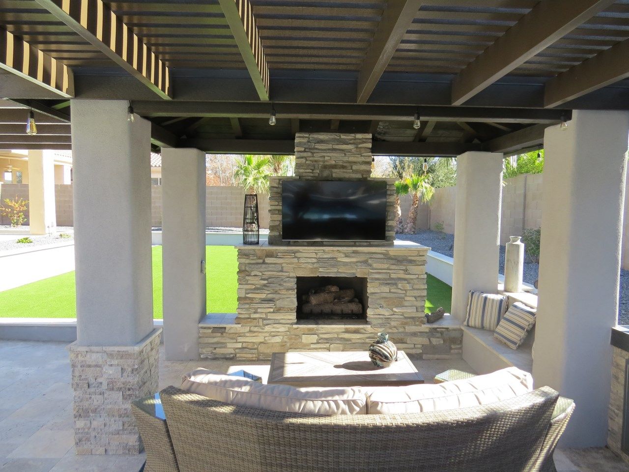A living room with a fireplace and a flat screen tv