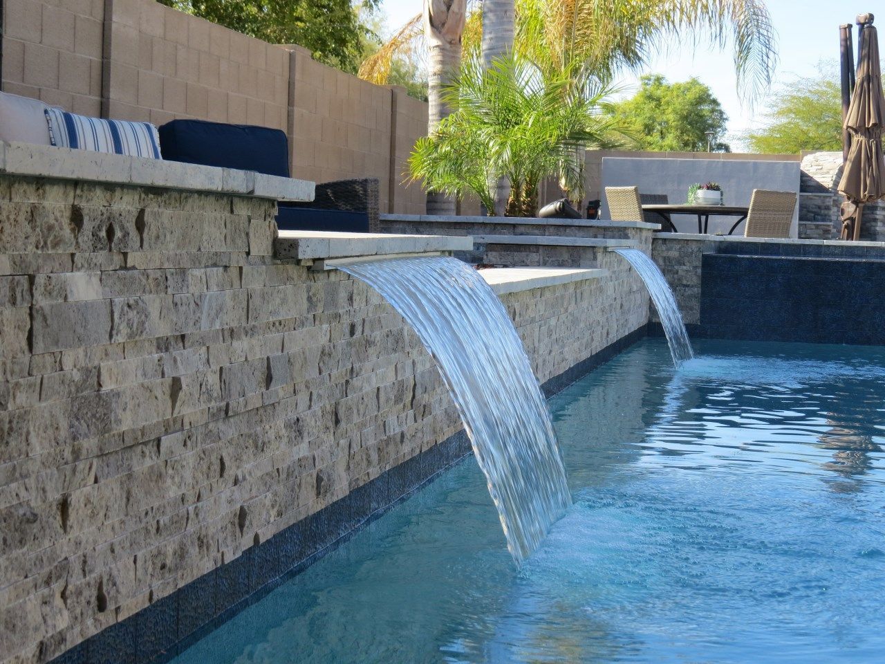 There is a waterfall in the middle of the pool.
