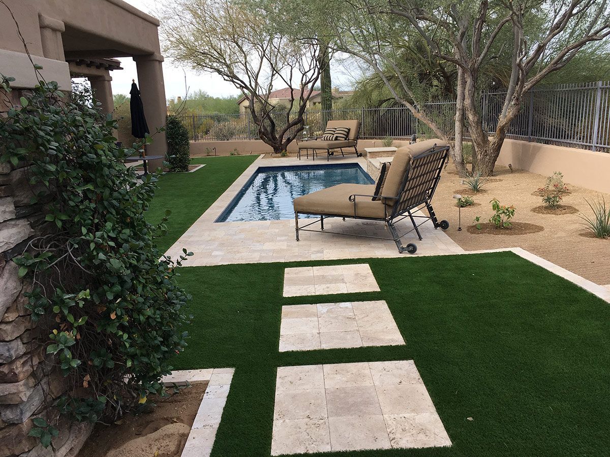 A backyard with a swimming pool and lawn chairs