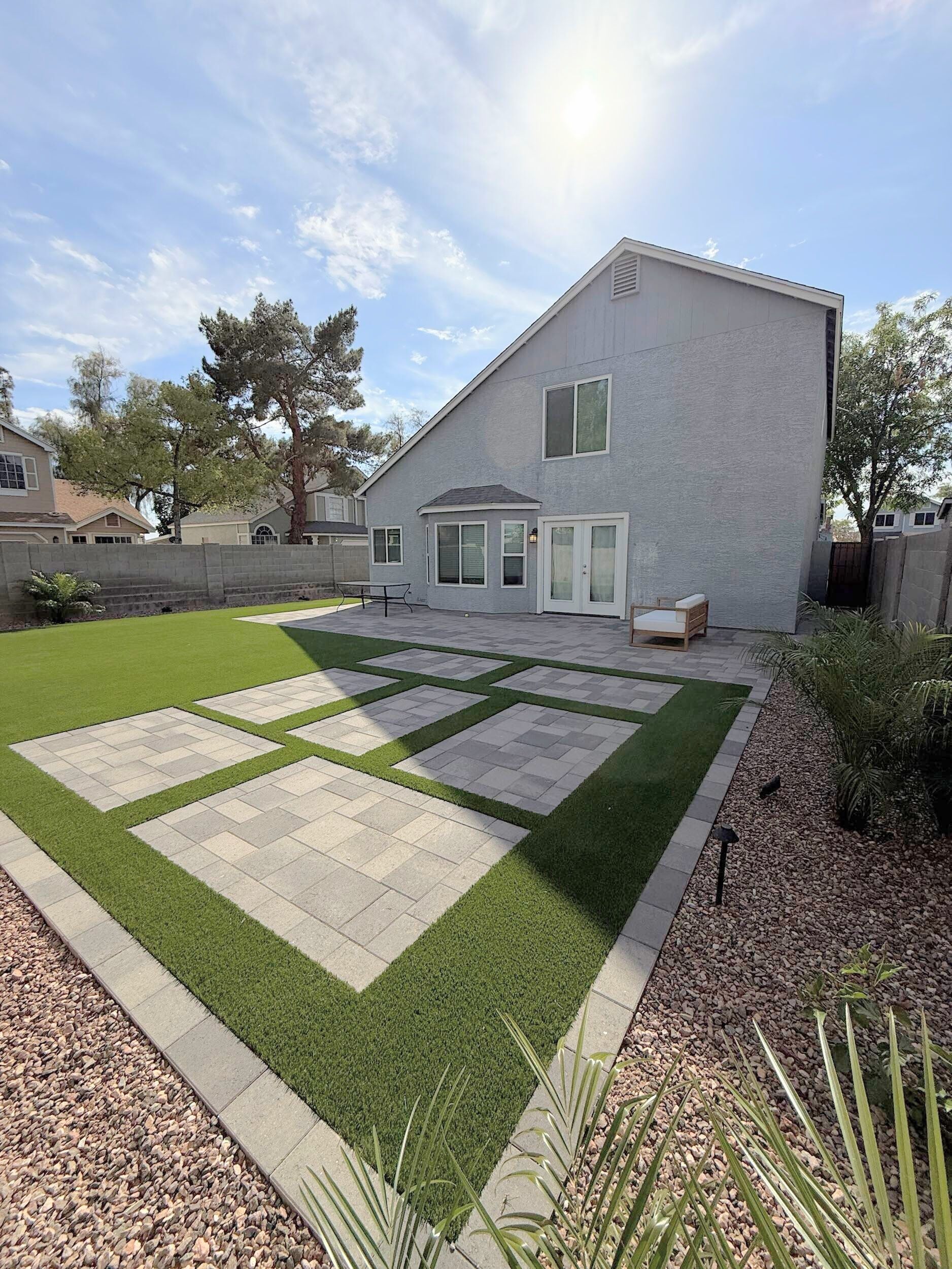 The backyard of a house with a large lawn