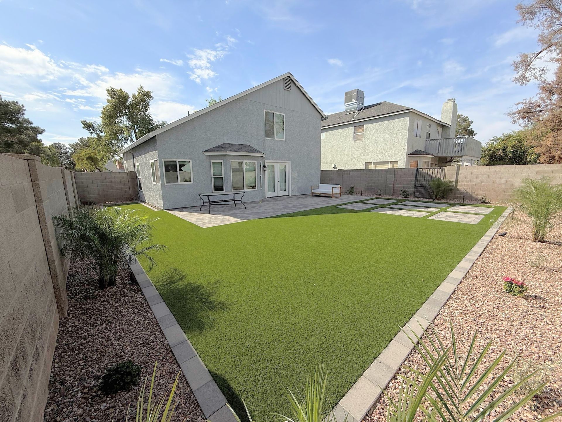 A house with a large lawn in front of it