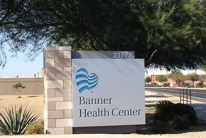 A banner health center sign with a tree in the background