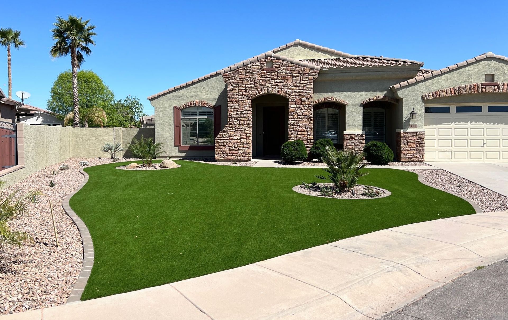 A house with a lush green lawn in front of it
