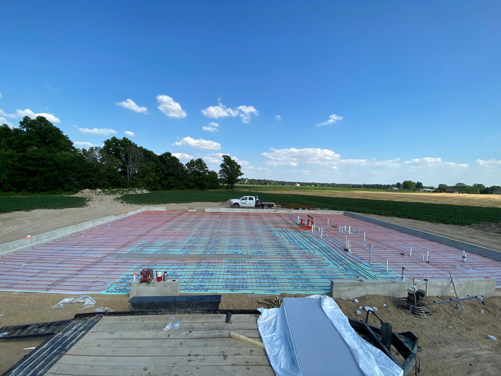 A large concrete slab is being built in a field.
