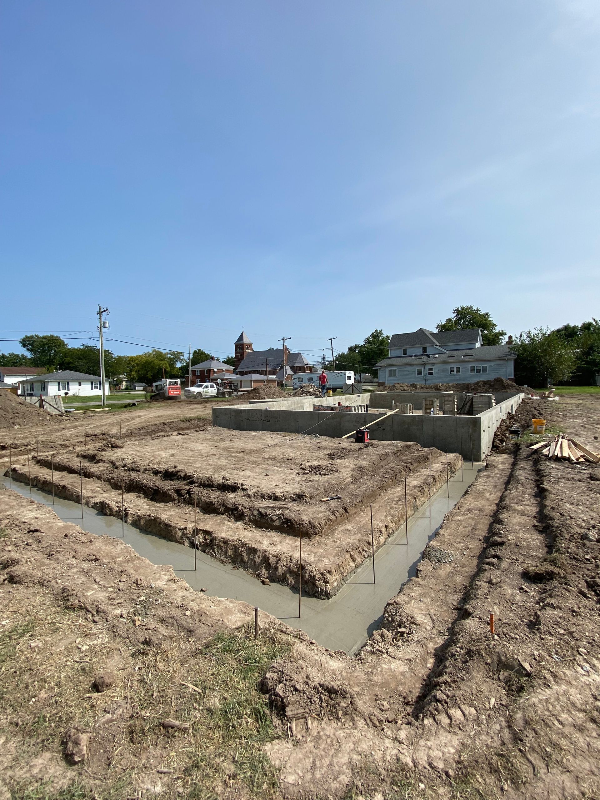 A house is being built in a dirt field.