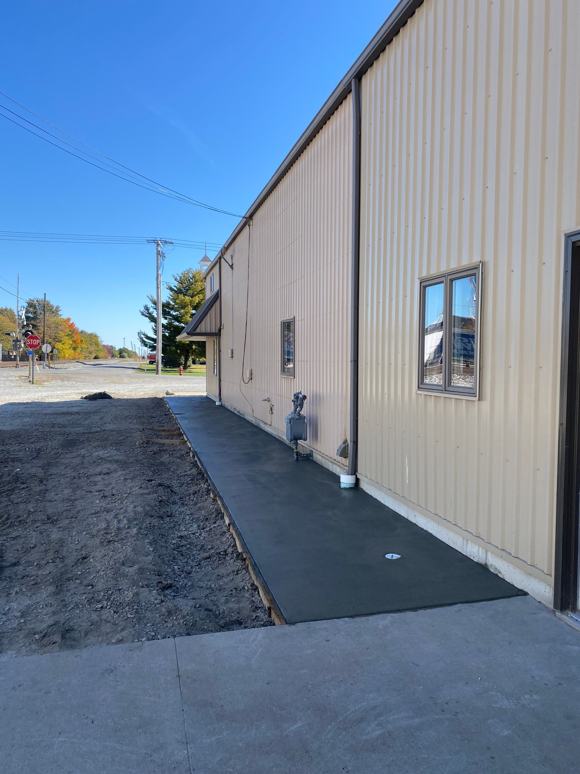 A large building with a concrete walkway leading to it.
