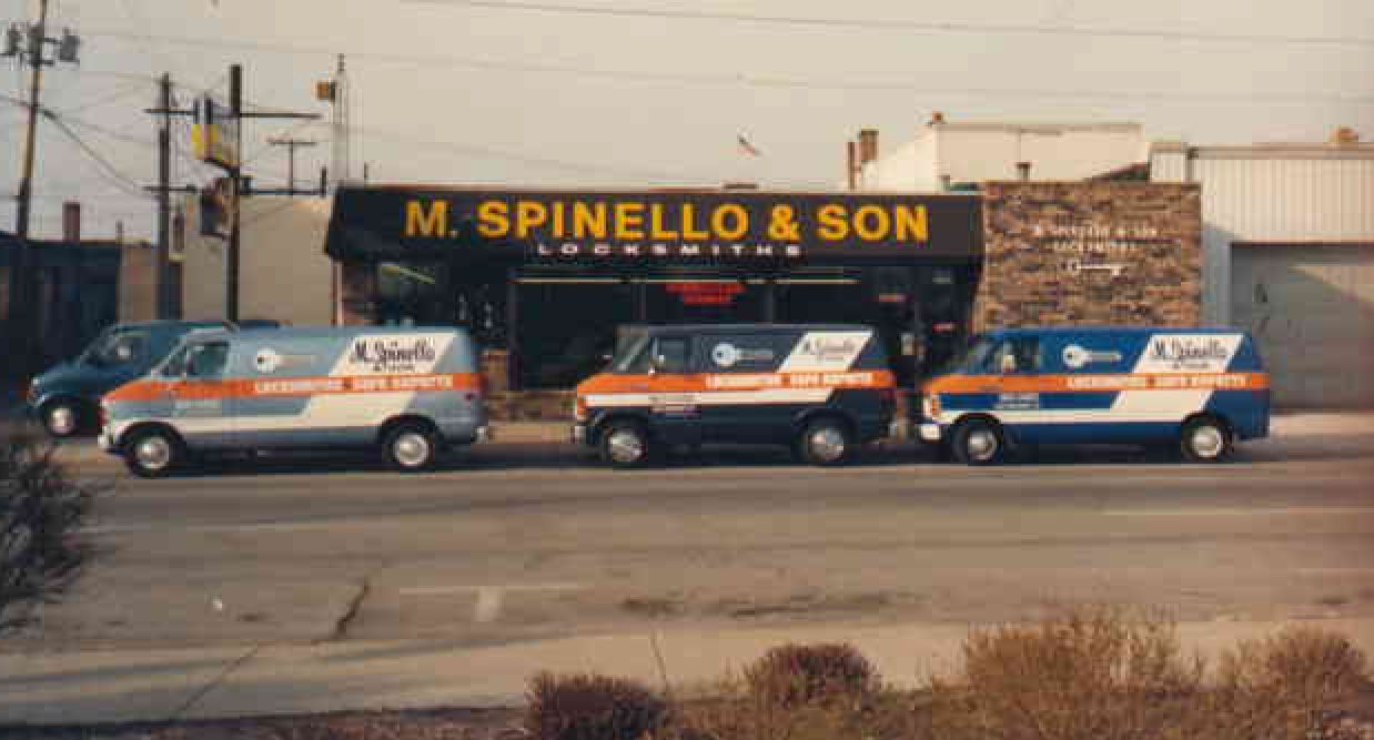 M. Spinello & Son locksmith shop with three service vans parked in front.