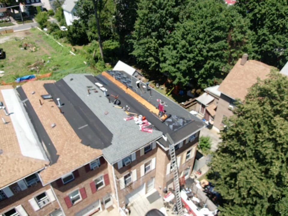 An aerial view of a roof being installed on a house