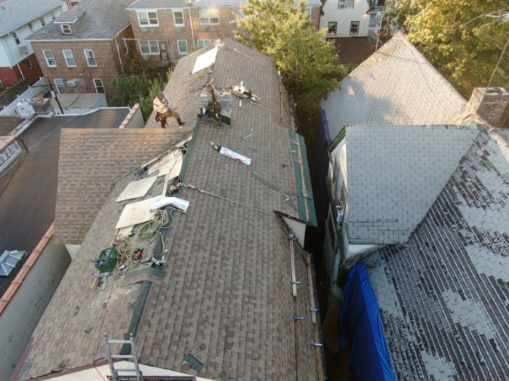 An aerial view of a roof that is being repaired.