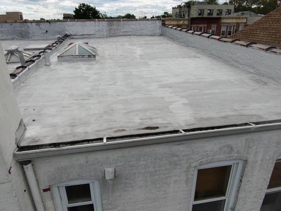 The roof of a building with a skylight on it.