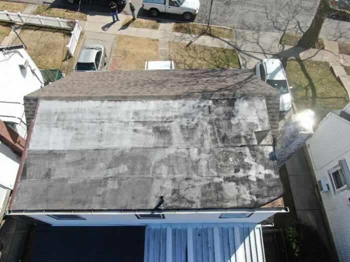An aerial view of a roof of a house in a residential area.