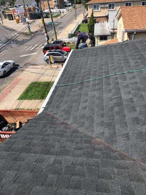 A man is working on the roof of a house.