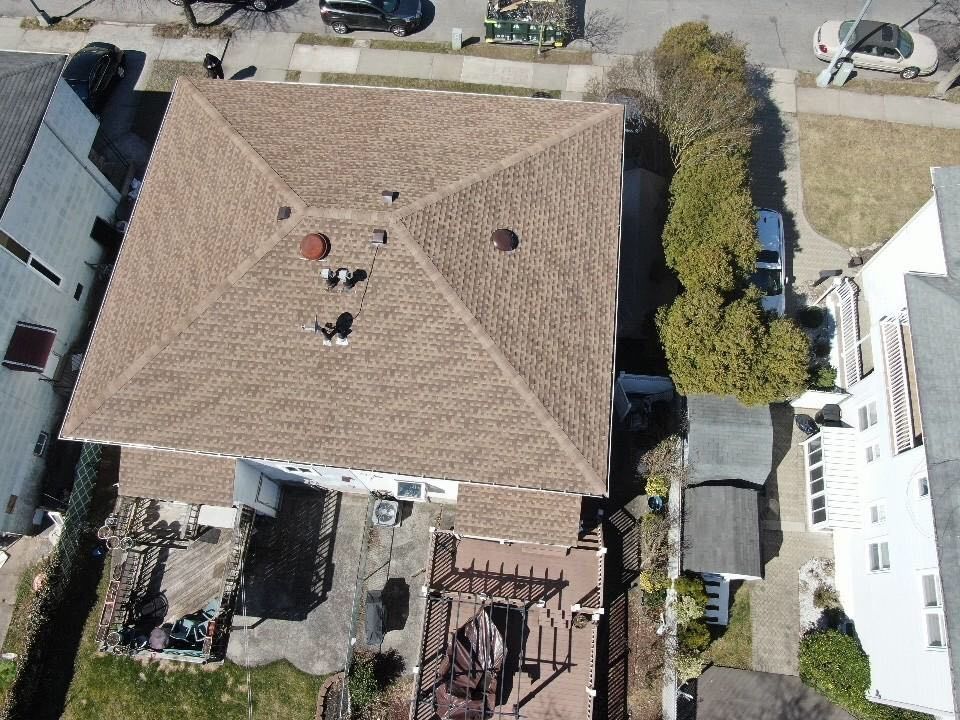 An aerial view of a house with a brown roof