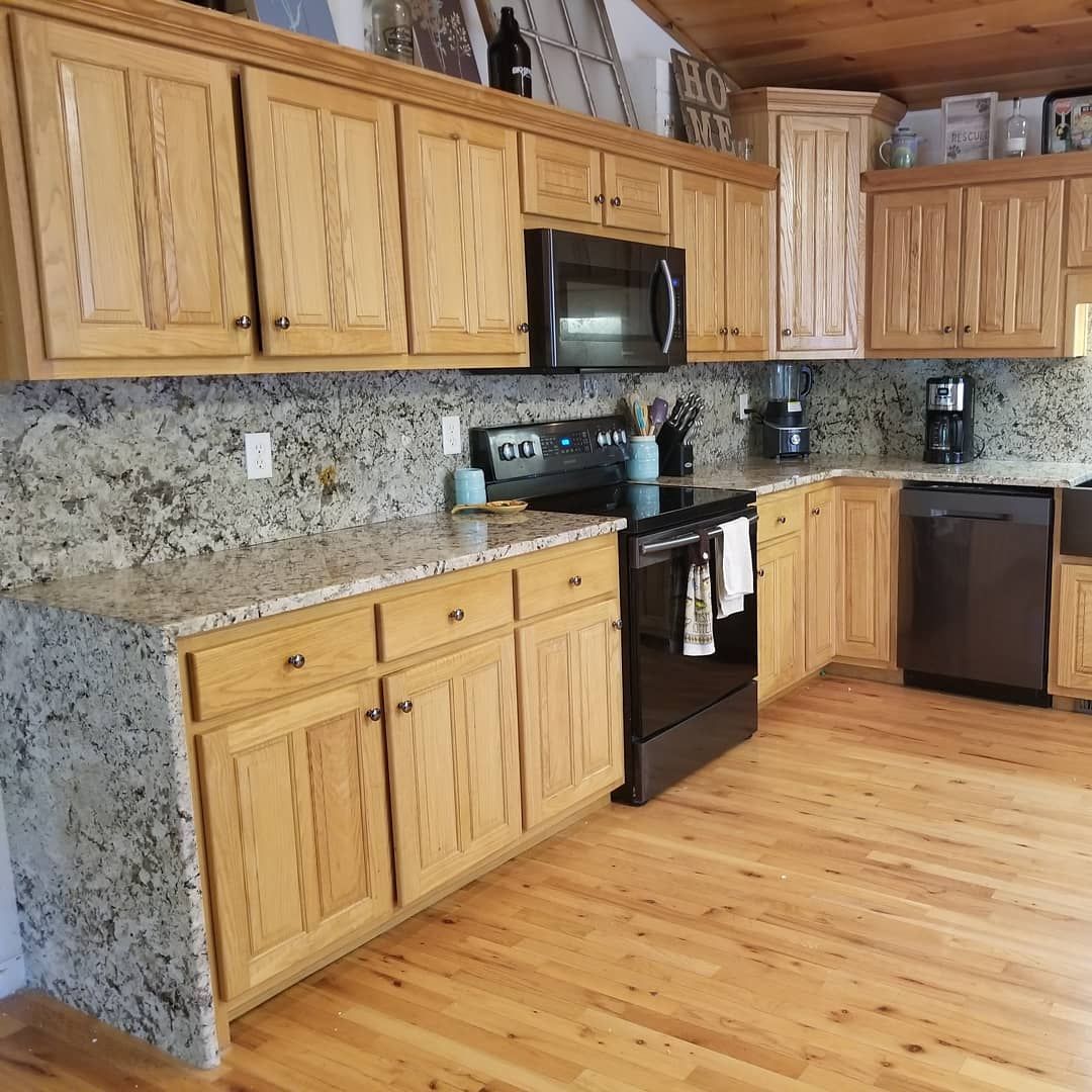 A kitchen with wooden cabinets and granite counter tops