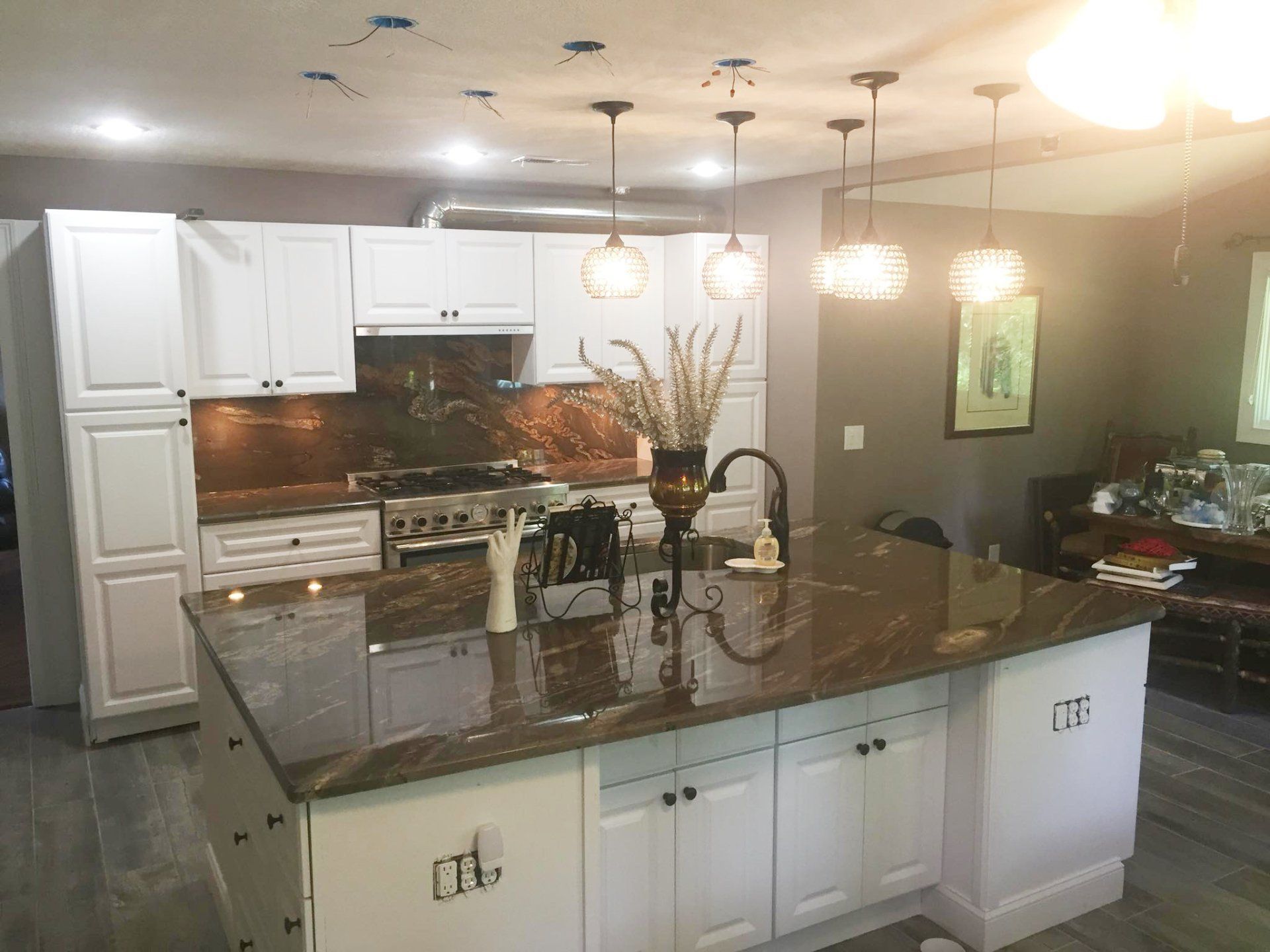 A kitchen with a sink and a christmas tree on the counter.