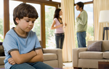 Young boy listening to parental fight in living room