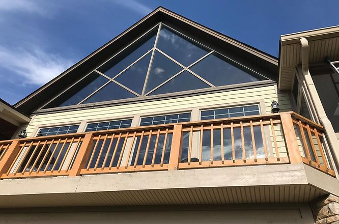 A large house with a balcony and a large window