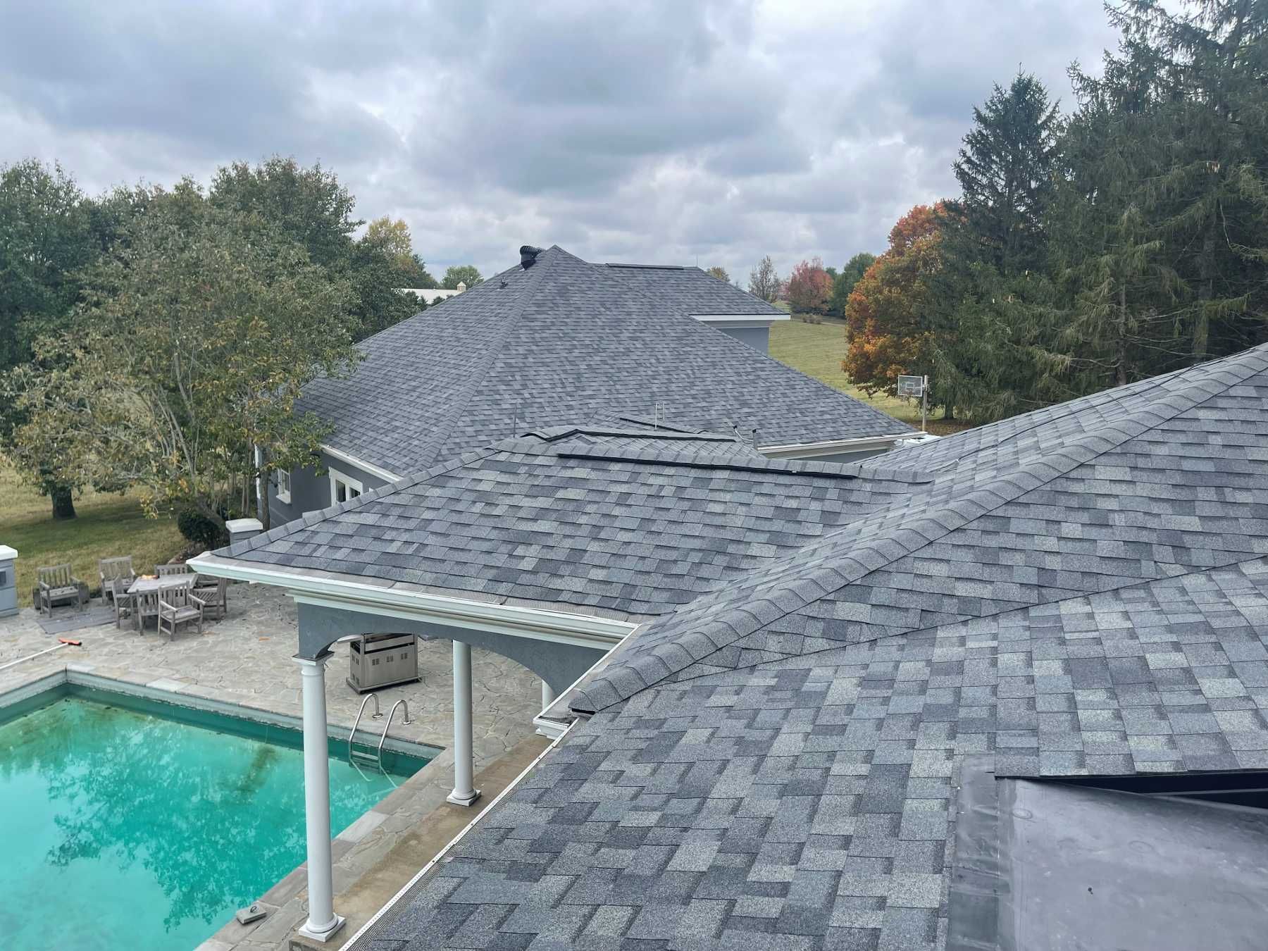 The roof of a house with a pool in the backyard.