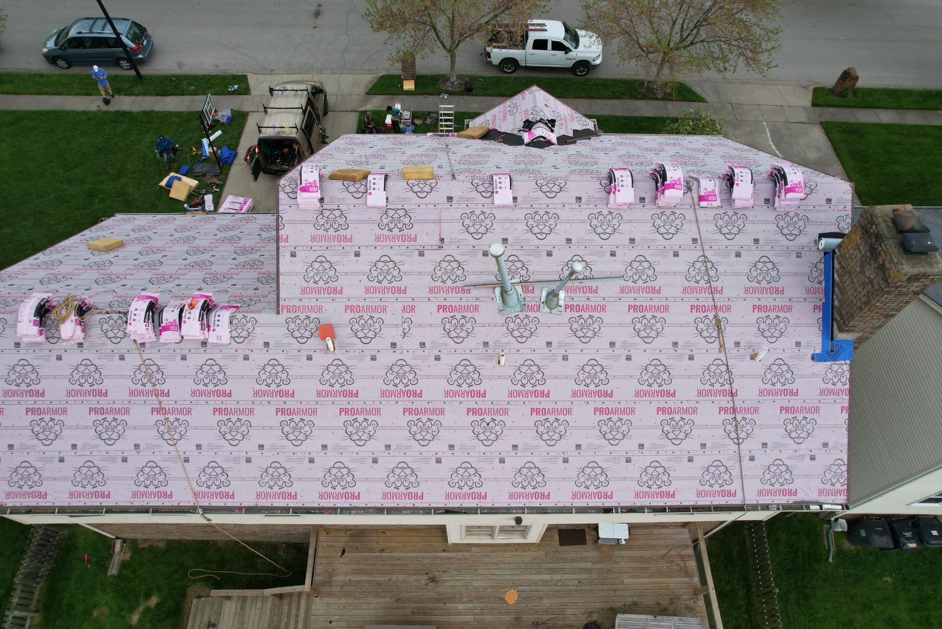 An aerial view of a house with a roof being installed.