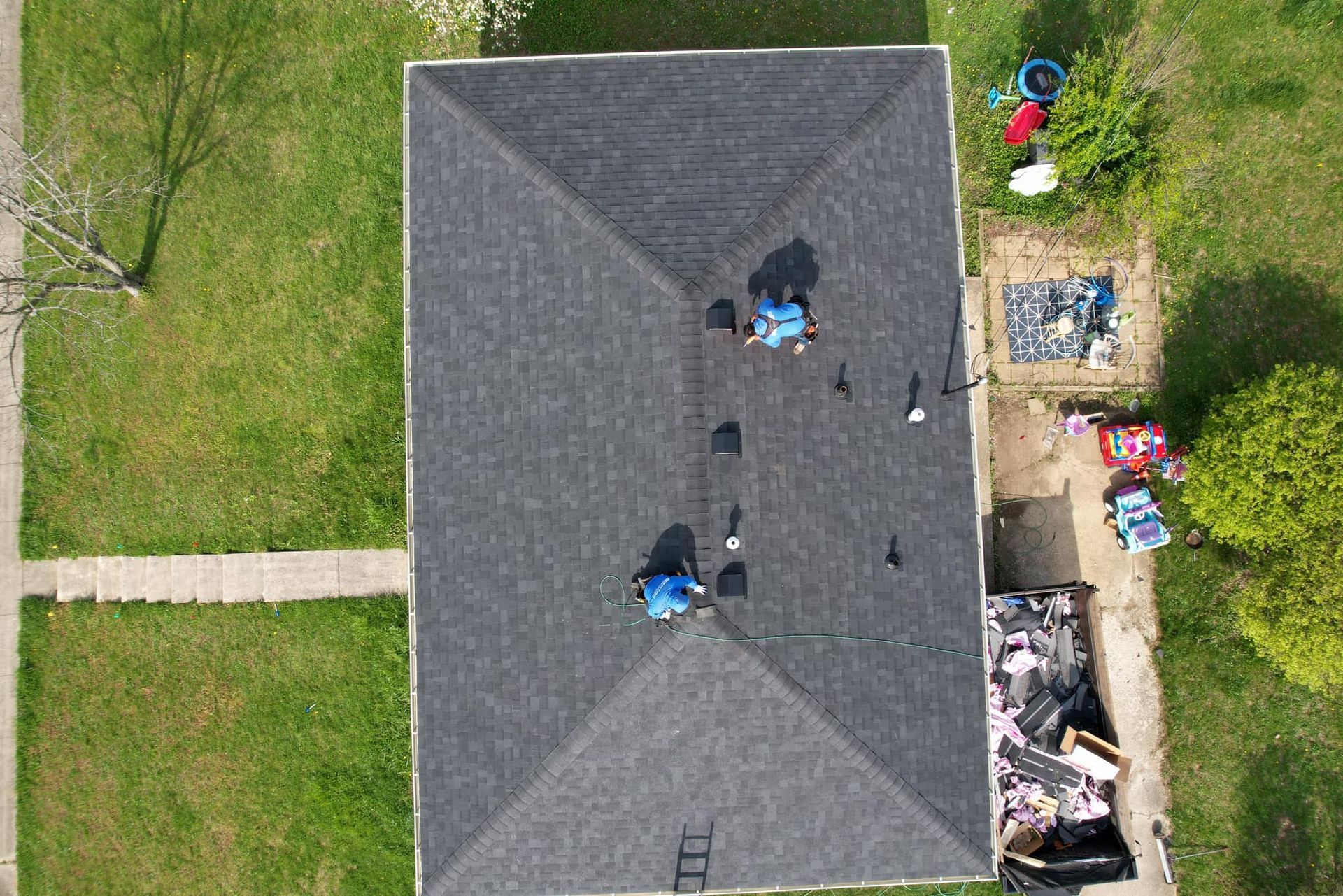 An aerial view of a house with a roof that is being repaired.