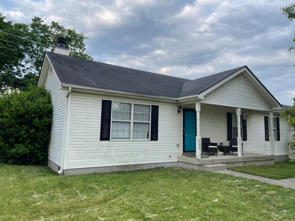 A white house with a blue door and black shutters